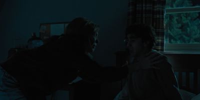 Still from Hereditary (2018) that has been tagged with: 000000 & medium wide & interior & night