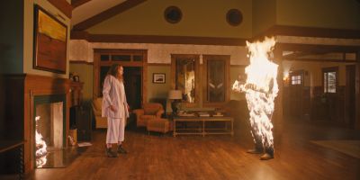 Still from Hereditary (2018) that has been tagged with: night & fireplace & living room & burning & two-shot & interior