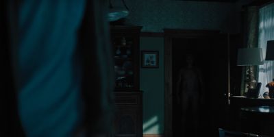 Still from Hereditary (2018) that has been tagged with: night & wide shot & over-the-shoulder & interior