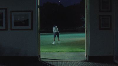 Still from Commercial: ADIDAS — "Impossible Is Nothing" that has been tagged with: golf-course & wide shot & golfing & over-the-shoulder
