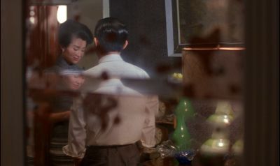 Still from In the Mood For Love (2000) that has been tagged with: night & over-the-shoulder & medium wide & interior