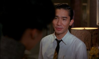 Still from In the Mood For Love (2000) that has been tagged with: night & medium shot & over-the-shoulder & interior