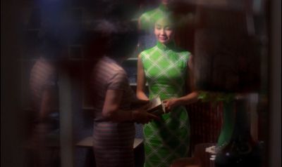 Still from In the Mood For Love (2000) that has been tagged with: 83bb63 & medium wide & night & two-shot