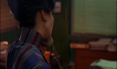 Still from In the Mood For Love (2000) that has been tagged with: night & phone & medium shot & over-the-shoulder & interior