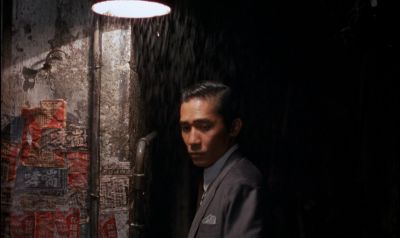 Still from In the Mood For Love (2000) that has been tagged with: rain & exterior & medium shot
