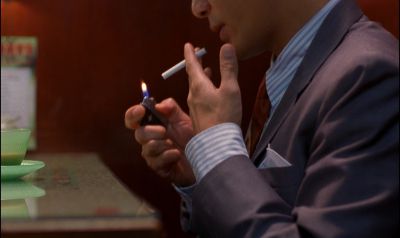 Still from In the Mood For Love (2000) that has been tagged with: night & insert & diner & smoking & cigarette