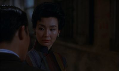 Still from In the Mood For Love (2000) that has been tagged with: night & medium close-up & over-the-shoulder