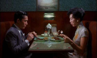 Still from In the Mood For Love (2000) that has been tagged with: night & medium wide & two-shot & chinese restaurant