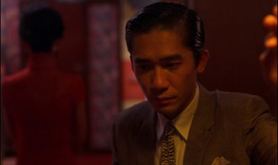 Still from In the Mood For Love (2000) that has been tagged with: interior & over-the-shoulder & medium close-up & clean single
