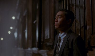 Still from In the Mood For Love (2000) that has been tagged with: night & medium shot & exterior & rain
