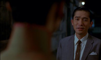 Still from In the Mood For Love (2000) that has been tagged with: over-the-shoulder & night & medium shot