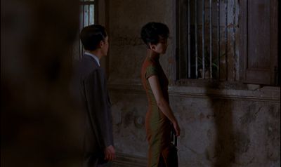 Still from In the Mood For Love (2000) that has been tagged with: medium wide & night & exterior