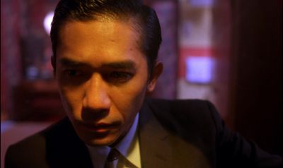 Still from In the Mood For Love (2000) that has been tagged with: c5b359 & night & close-up & interior