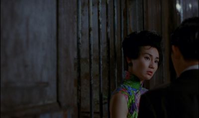Still from In the Mood For Love (2000) that has been tagged with: medium shot & medium wide & over-the-shoulder & night & exterior