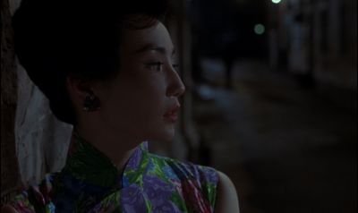 Still from In the Mood For Love (2000) that has been tagged with: medium close-up & clean single & exterior & night & profile shot