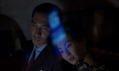 Still from In the Mood For Love (2000) that has been tagged with: night & interior & two-shot & medium close-up & car interior