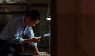 Still from In the Mood For Love (2000) that has been tagged with: interior & night & medium shot & clean single