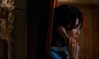 Still from In the Mood For Love (2000) that has been tagged with: phone & night & medium close-up