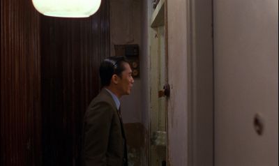 Still from In the Mood For Love (2000) that has been tagged with: night & doorway & clean single & interior & medium wide