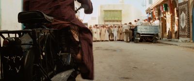 Still from Indiana Jones and the Raiders of the Lost Ark (1981) that has been tagged with: crowd & wide shot & motorcycle