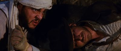 Still from Indiana Jones and the Raiders of the Lost Ark (1981) that has been tagged with: two-shot & laying down & exterior & night