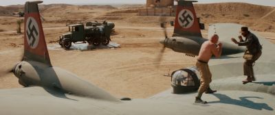 Still from Indiana Jones and the Raiders of the Lost Ark (1981) that has been tagged with: desert & fight & swastika & airplane