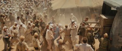 Still from Indiana Jones and the Raiders of the Lost Ark (1981) that has been tagged with: crowd & high-angle & extreme wide & truck & gun & desert