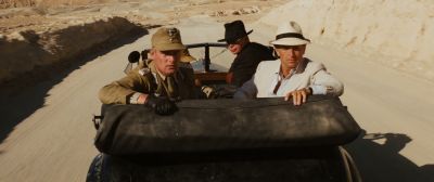 Still from Indiana Jones and the Raiders of the Lost Ark (1981) that has been tagged with: looking down & medium wide & high-angle & convertable & exterior & car
