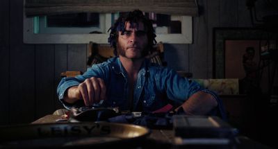 Still from Inherent Vice (2014) that has been tagged with: ab4f53 & night & clean single & smoking & medium shot