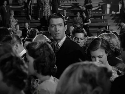 Still from It's A Wonderful Life (1946) that has been tagged with: group-shot & black and white & interior