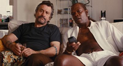 Still from Jackie Brown (1997) that has been tagged with: couch & medium wide & living room & remote control & day
