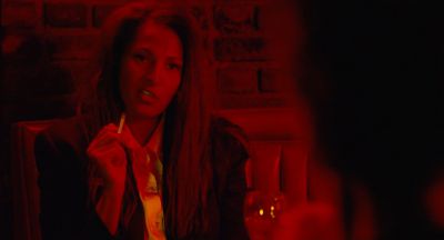 Still from Jackie Brown (1997) that has been tagged with: medium shot & cigarette & bar & interior