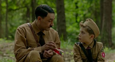 Still from JoJo Rabbit (2019) that has been tagged with: two-shot & hitler & day & cigarette