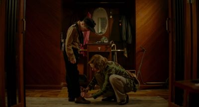 Still from JoJo Rabbit (2019) that has been tagged with: day & tying shoe & wide shot & child & interior
