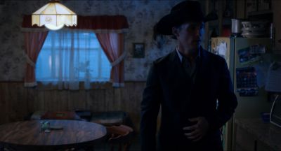 Still from Killer Joe (2011) that has been tagged with: night & practical lamp & clean single & kitchen & medium wide & cowboy