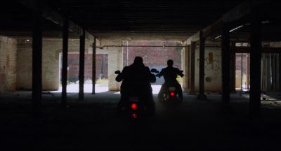 Still from Killer Joe (2011) that has been tagged with: ff0037 & wide shot & motorcycle & two-shot & warehouse