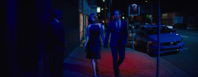Still from La La Land (2016) that has been tagged with: night & street & exterior & sidewalk & holding hands