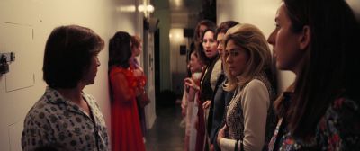 Still from Licorice Pizza (2021) that has been tagged with: night & hallway & group-shot