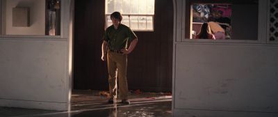 Still from Licorice Pizza (2021) that has been tagged with: wide shot & day & interior & doorway & clean single