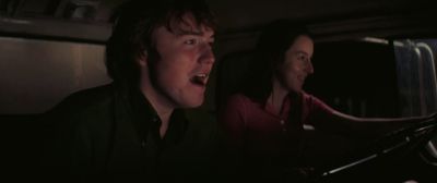 Still from Licorice Pizza (2021) that has been tagged with: medium close-up & car & night & car interior & interior & truck