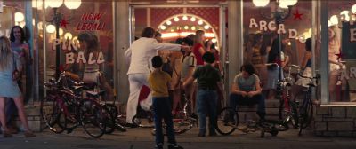 Still from Licorice Pizza (2021) that has been tagged with: 714f38 & exterior & night & bicycle