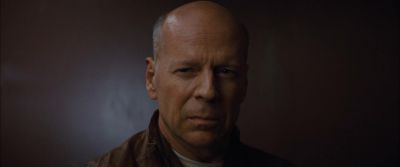 Still from Looper (2012) that has been tagged with: 8b8488 & day & close-up