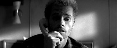 Still from Memento (2000) that has been tagged with: d4d4d4 & interior & medium close-up & clean single