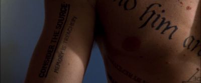 Still from Memento (2000) that has been tagged with: tattoo & insert & day & extreme close-up