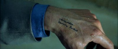 Still from Memento (2000) that has been tagged with: hand & day