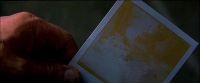 Still from Memento (2000) that has been tagged with: extreme close-up & hand & polaroid
