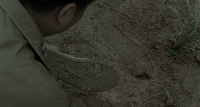 Still from Memories of Murder (2003) that has been tagged with: over-the-shoulder & day & footprint