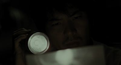 Still from Memories of Murder (2003) that has been tagged with: reading & flashlight