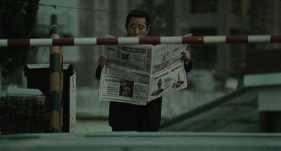 Still from Memories of Murder (2003) that has been tagged with: reading & train crossing