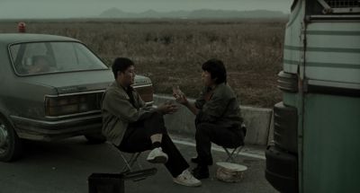 Still from Memories of Murder (2003) that has been tagged with: exterior & two-shot & day & road